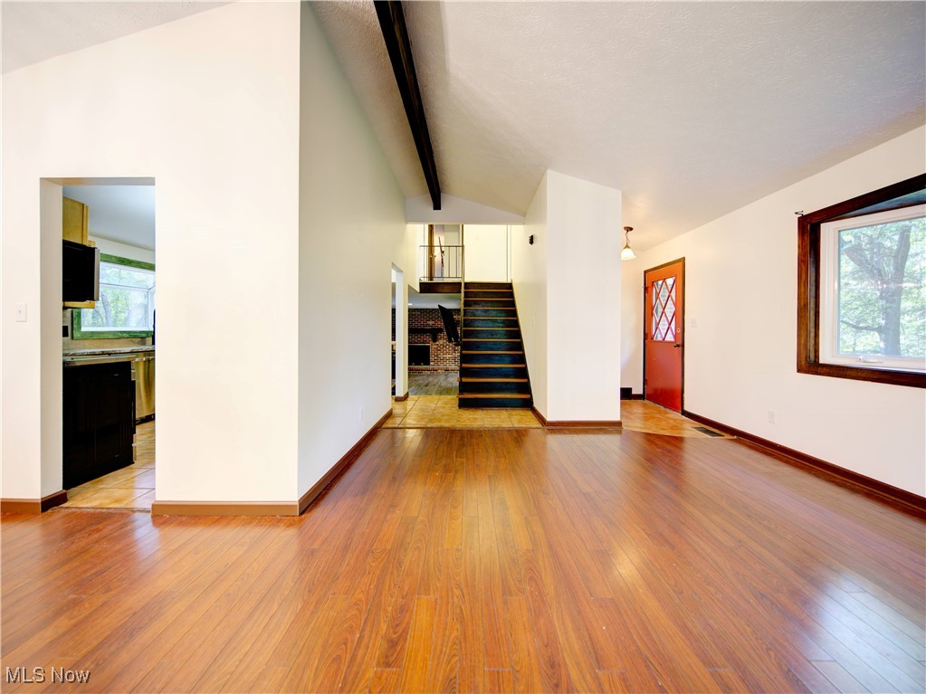8075 Mulberry Road Chesterland, OH 44026 - Photo 6 of 38 Unfurnished living room with light wood-style floors and stairway