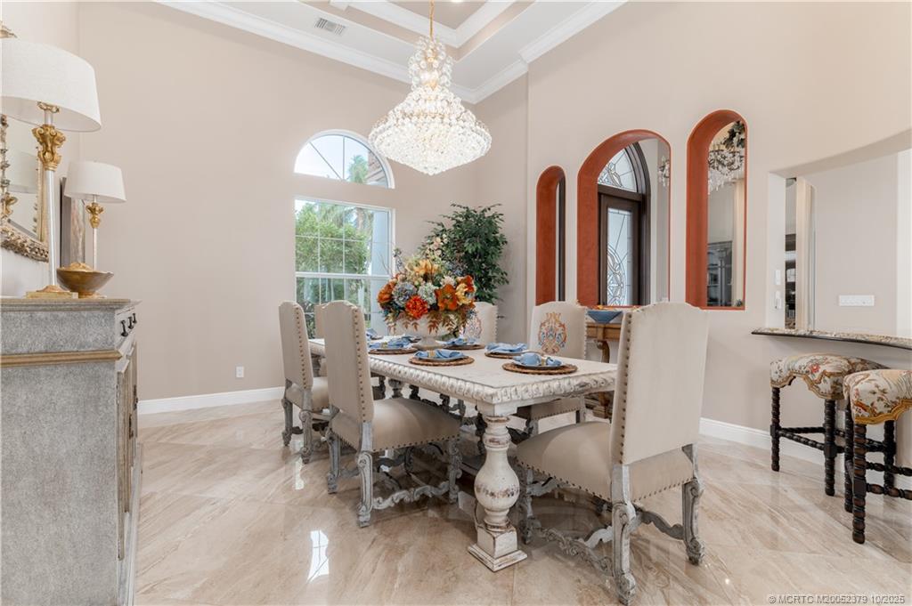 2690 Northwest Collins Cove Road Stuart, FL 34994 - Photo 24 of 100 a view of a dining room with furniture and a chandelier