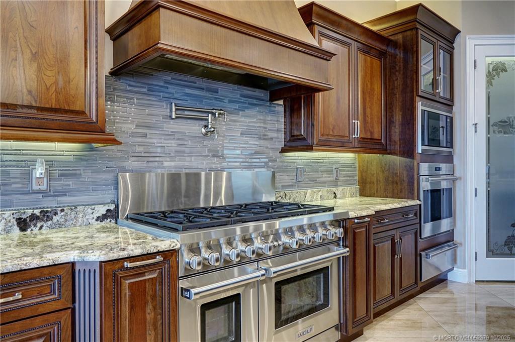2690 Northwest Collins Cove Road Stuart, FL 34994 - Photo 30 of 100 a stove top oven sitting inside of a kitchen