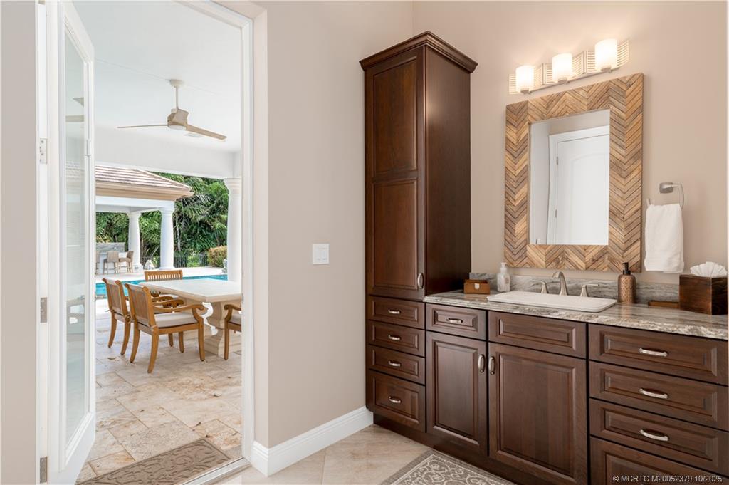 2690 Northwest Collins Cove Road Stuart, FL 34994 - Photo 40 of 100 a en suite bathroom with a granite countertop sink and a mirror