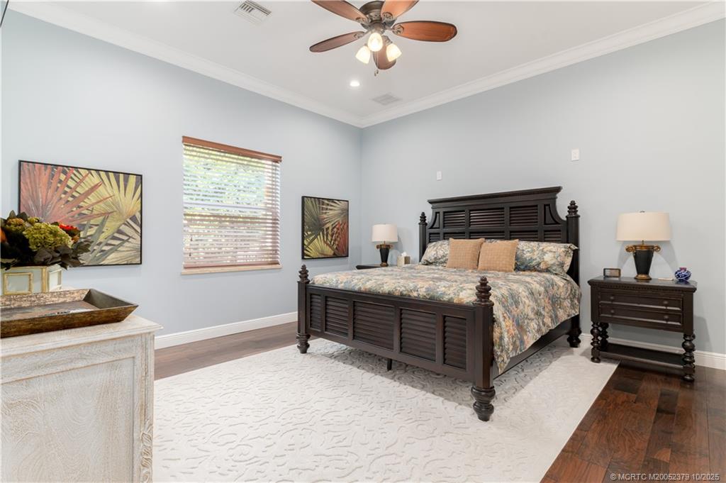 2690 Northwest Collins Cove Road Stuart, FL 34994 - Photo 54 of 100 a bedroom with a bed and a window