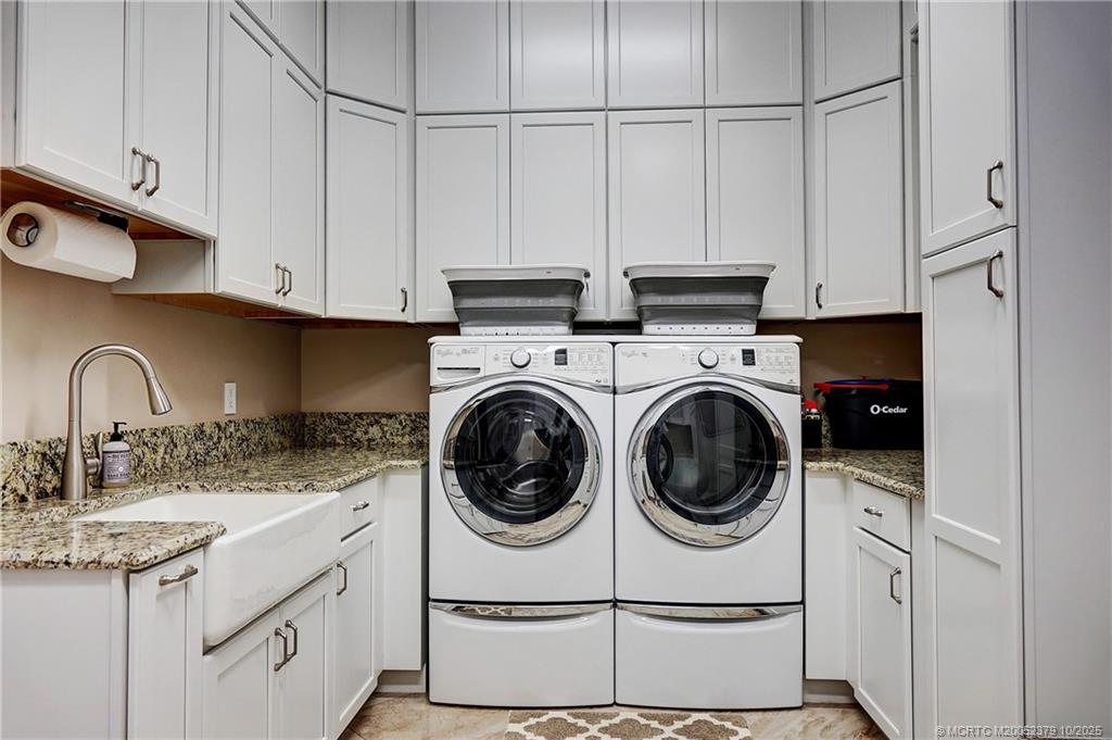2690 Northwest Collins Cove Road Stuart, FL 34994 - Photo 56 of 100 a kitchen with white cabinets and white appliances