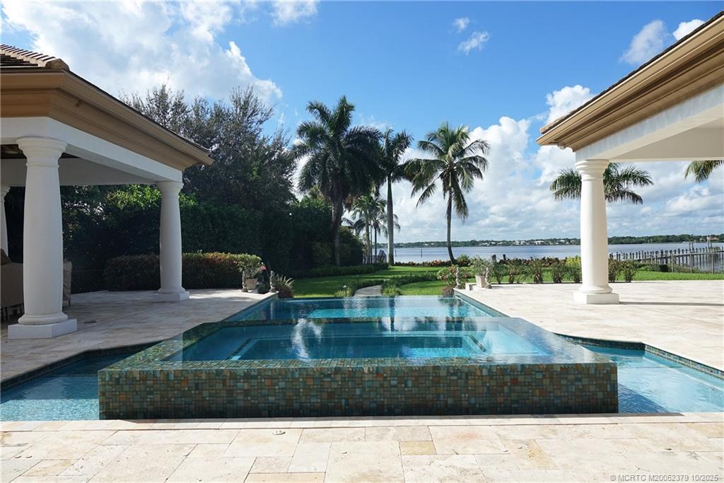2690 Northwest Collins Cove Road Stuart, FL 34994 - Photo 62 of 100 a view of a backyard with a patio