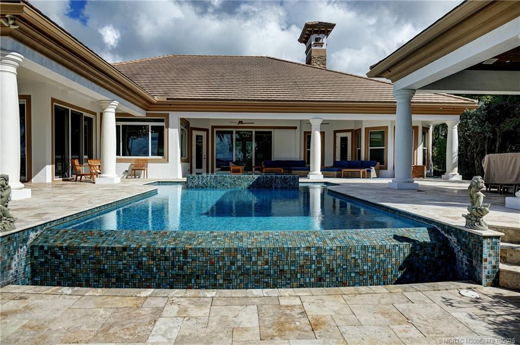 2690 Northwest Collins Cove Road Stuart, FL 34994 - Photo 63 of 100 a front view of a house with swimming pool