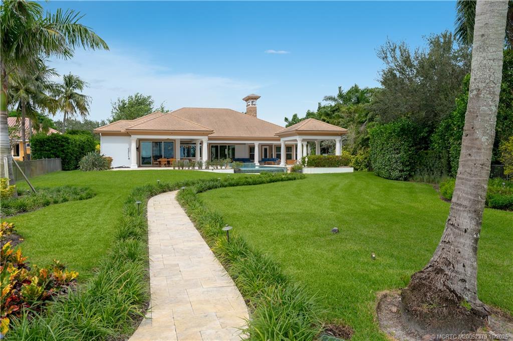 2690 Northwest Collins Cove Road Stuart, FL 34994 - Photo 84 of 100 a front view of a house with a yard