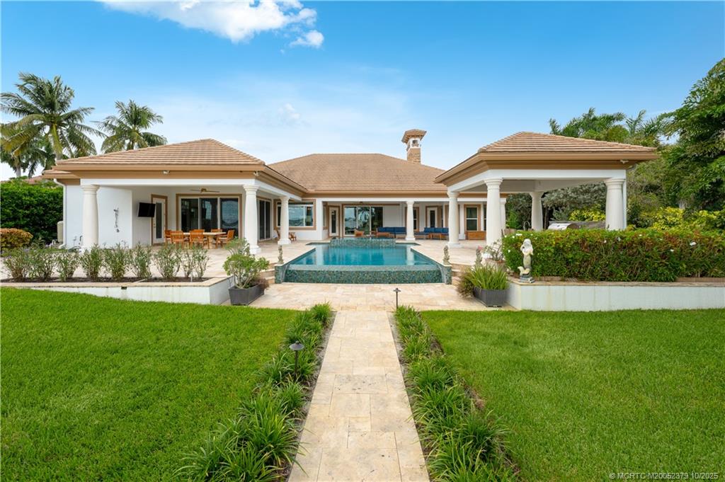 2690 Northwest Collins Cove Road Stuart, FL 34994 - Photo 85 of 100 a front view of a house with garden and patio
