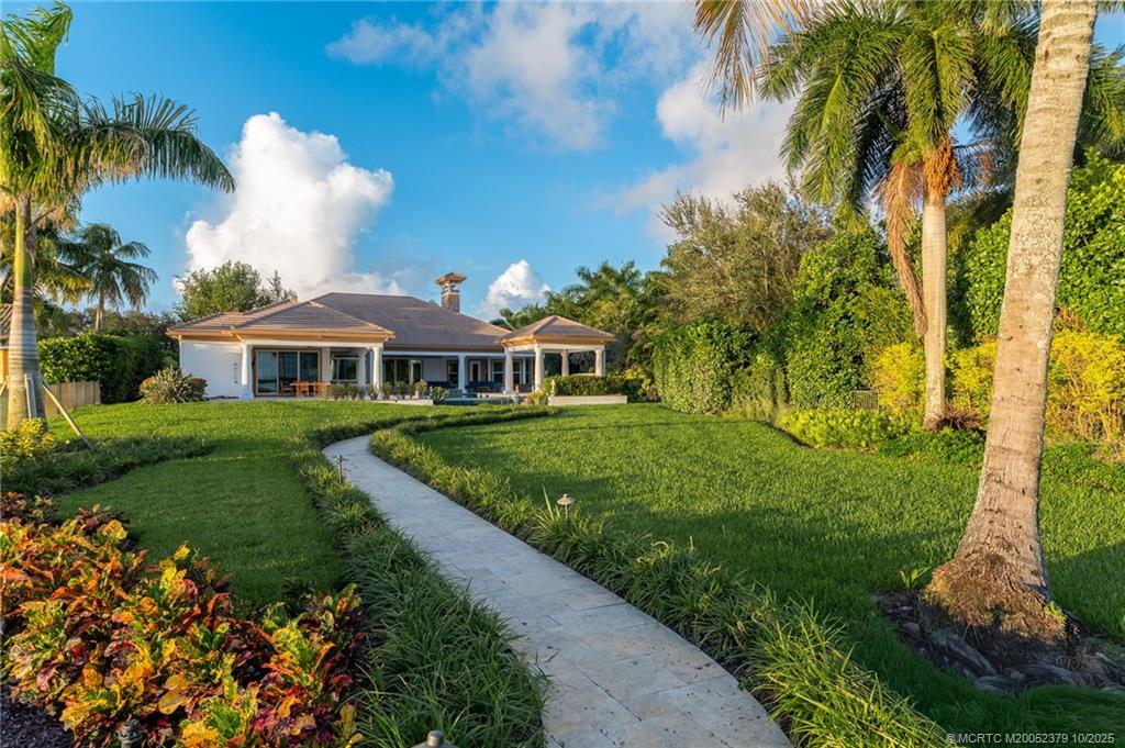 2690 Northwest Collins Cove Road Stuart, FL 34994 - Photo 90 of 100 a aerial view of a house with a yard and potted plants
