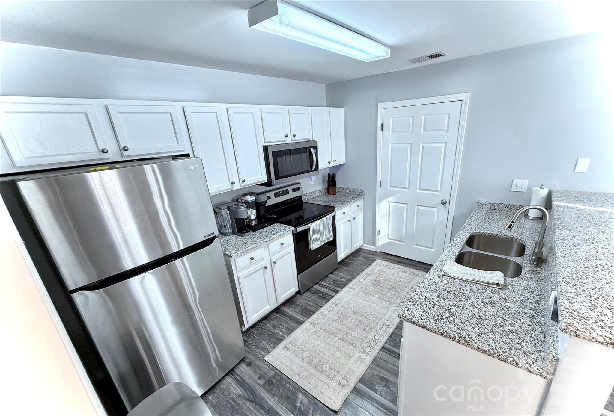 7479 Bluff Point Lane, Unit 13 Denver, NC 28037 - Photo 11 of 26 a kitchen with granite countertop a refrigerator stove and sink