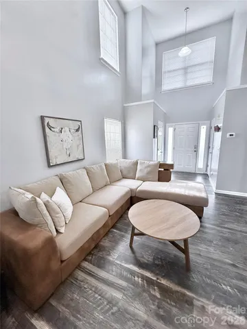 a living room with furniture a rug and a chandelier