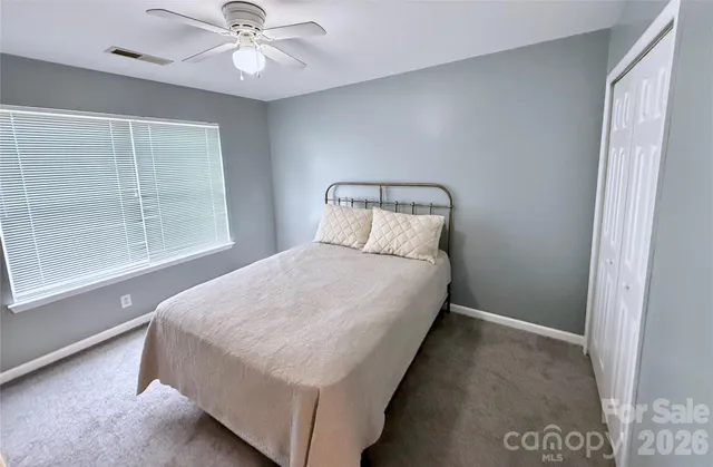 a bed sitting in a bedroom next to a window