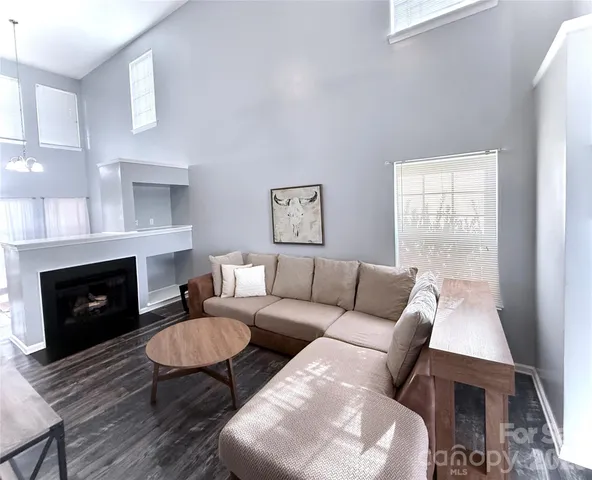 a living room with furniture a fireplace and a table