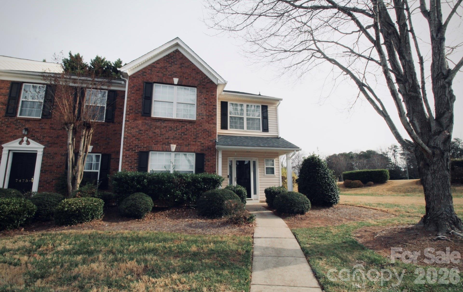 7479 Bluff Point Lane, Unit 13 Denver, NC 28037 - Photo 23 of 26 a front view of a house with garden and trees
