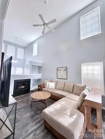 a living room with furniture fireplace and a window