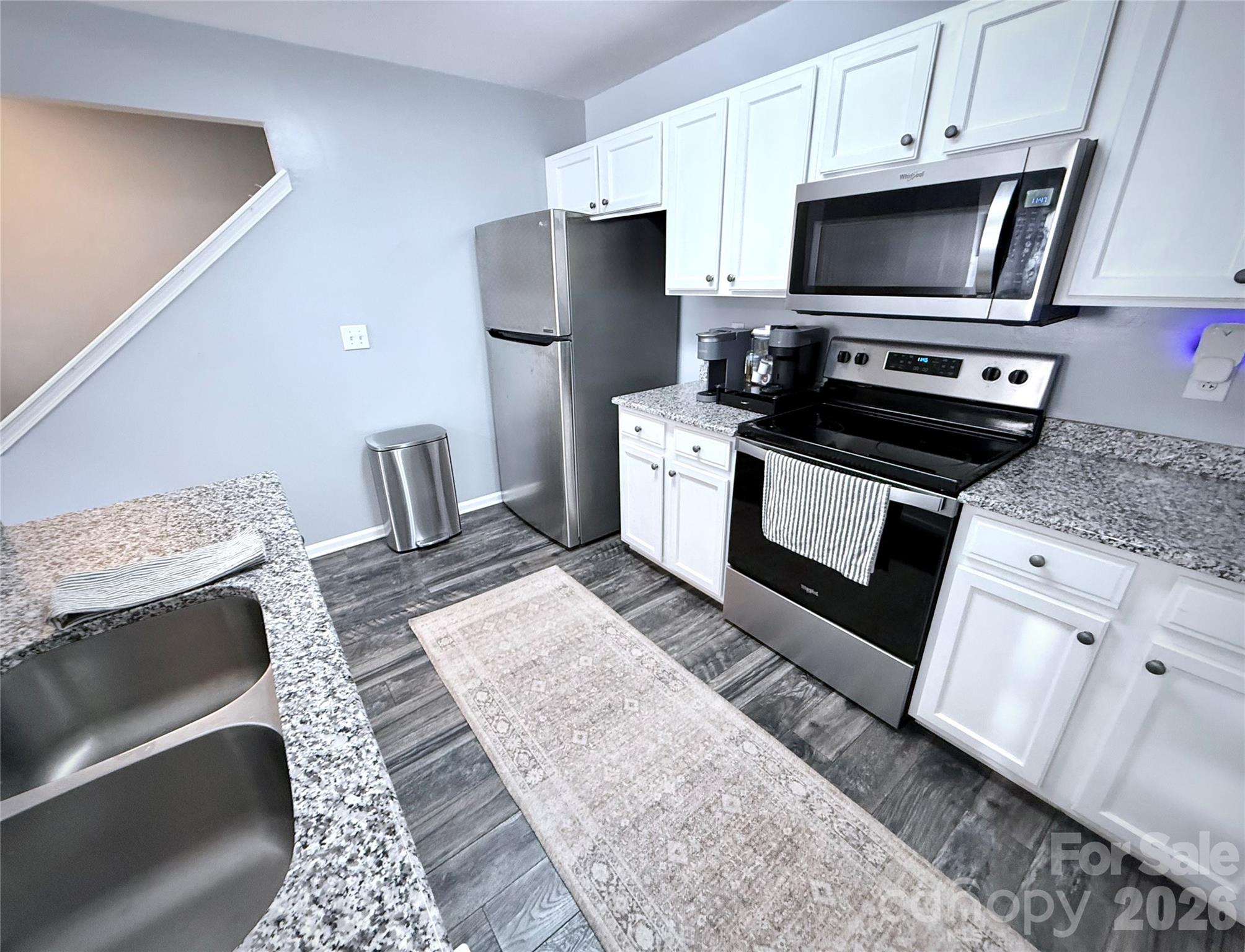 7479 Bluff Point Lane, Unit 13 Denver, NC 28037 - Photo 10 of 26 a kitchen with a stove a sink and a microwave