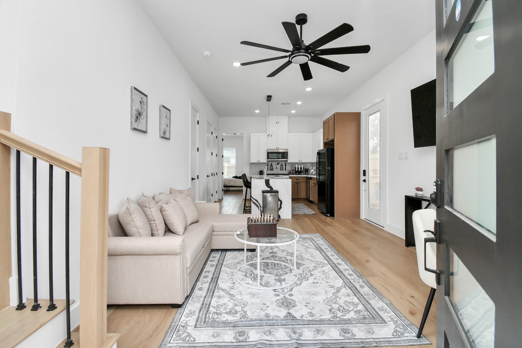 a living room with furniture and kitchen view