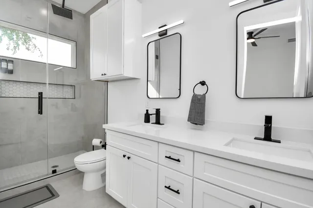 a large white bed in a black room