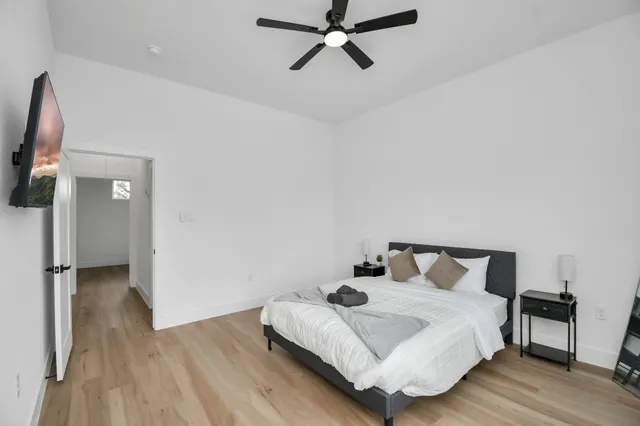 a view of a backyard with a chair and potted plants
