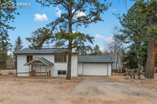 a house that has a tree in front of it