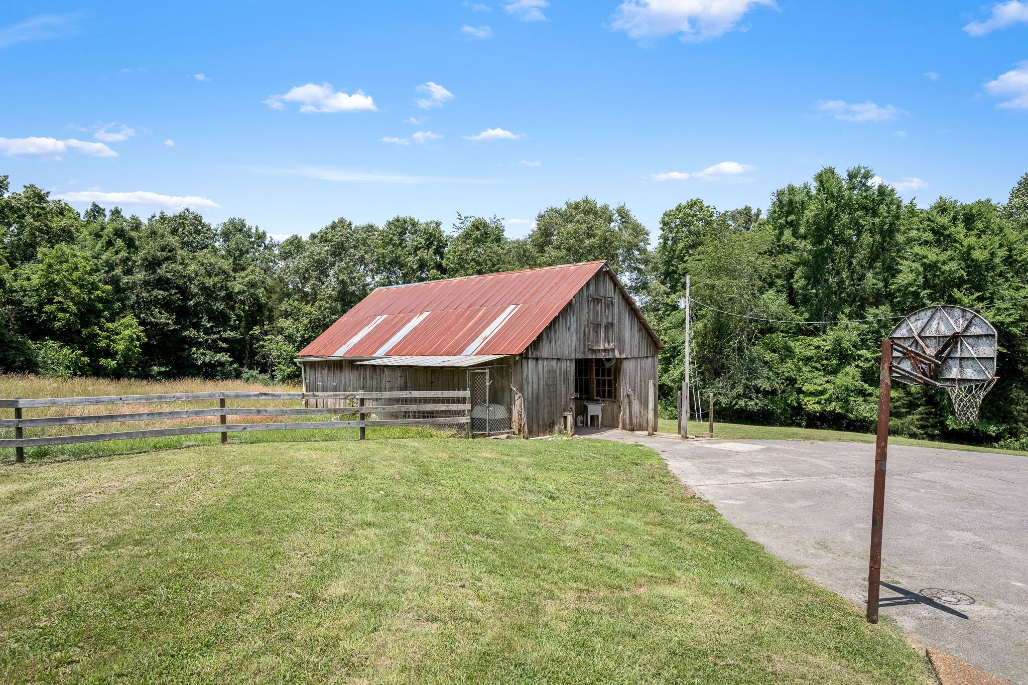 250 Home Pl Road Dickson, TN 37055 - Photo 61 of 62 a yellow and red house with a big yard and large trees
