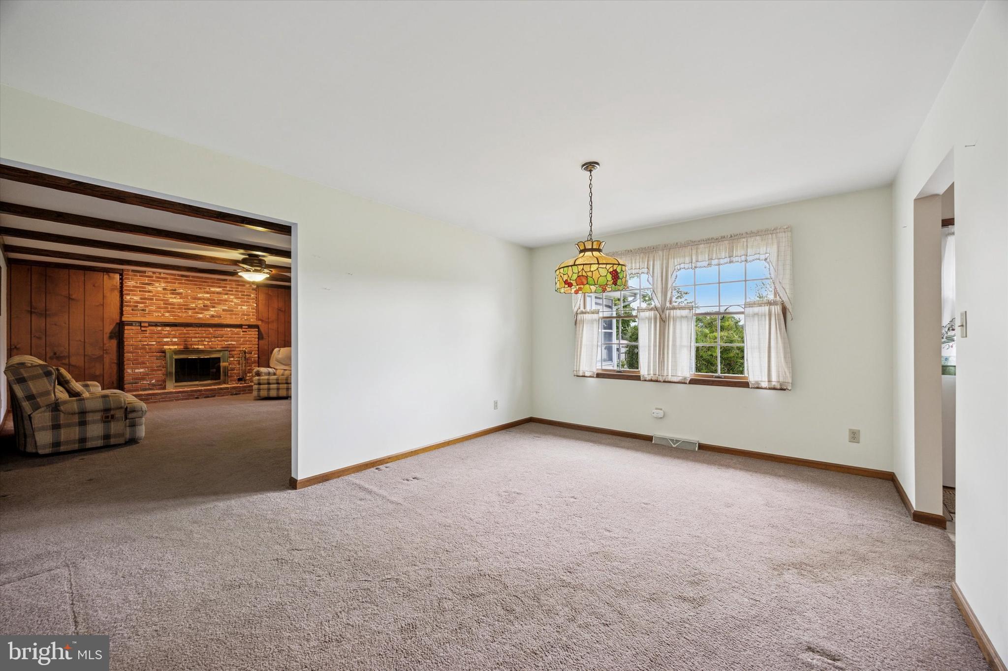 1690 Kumry Road Quakertown, PA 18951 - Photo 12 of 34 an empty room with windows and chandelier