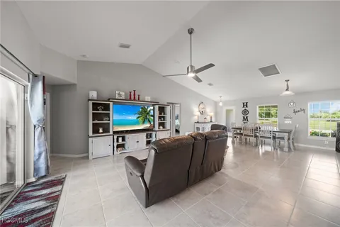a living room with furniture a window and a flat screen tv