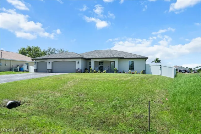 a front view of a house with a garden