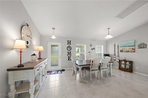 a view of a dining room with furniture and a chandelier