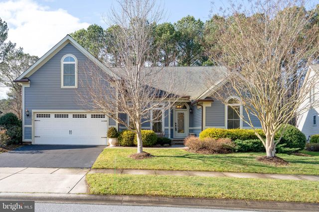 a view of a white house with a yard