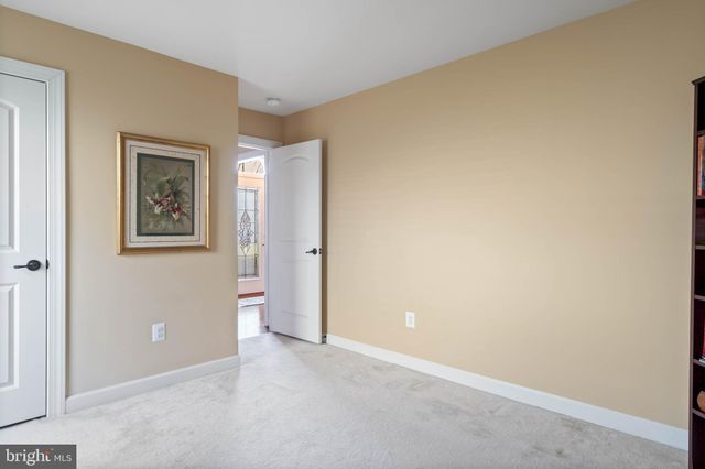 a view of a kitchen with kitchen island granite countertop wooden floors and wide window