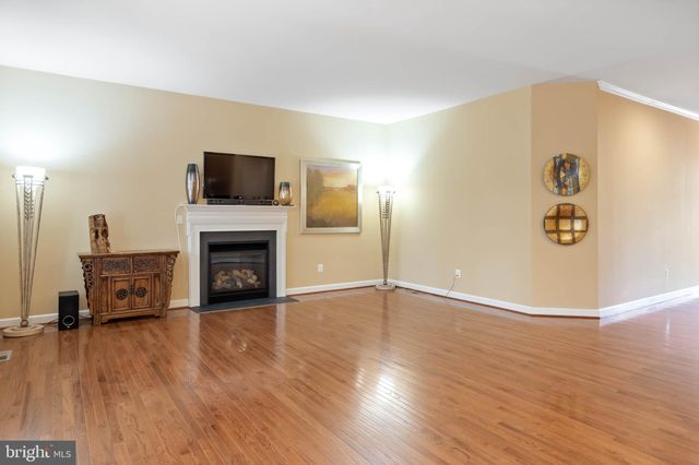 a kitchen with stainless steel appliances granite countertop a refrigerator a stove a sink and a microwave