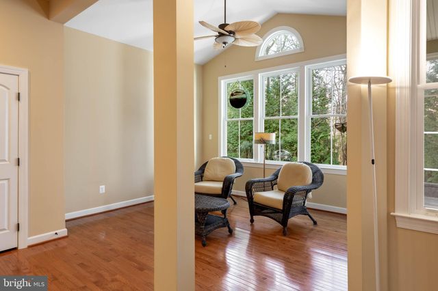 a bathroom with a granite countertop sink toilet a mirror and shower