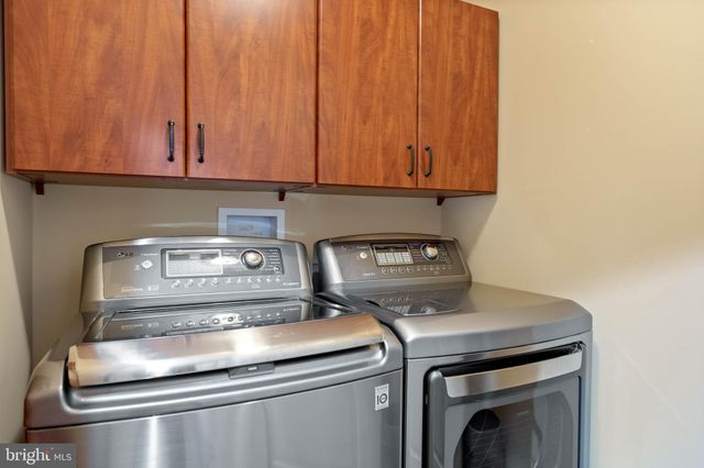 a living room with furniture a window and a chandelier