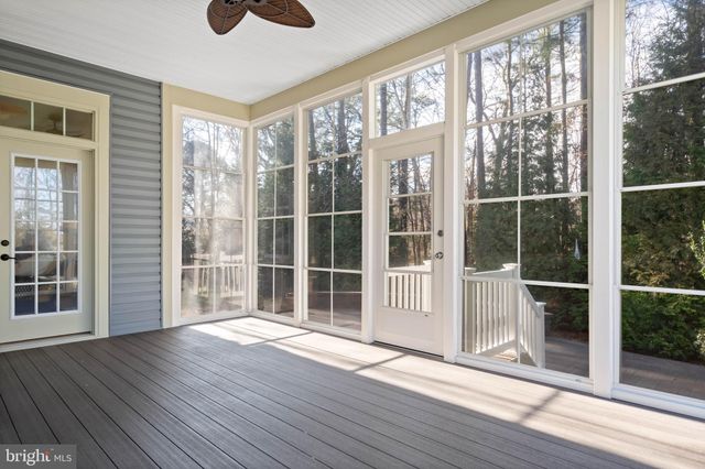 a living room with furniture a fireplace and a dining table with wooden floor