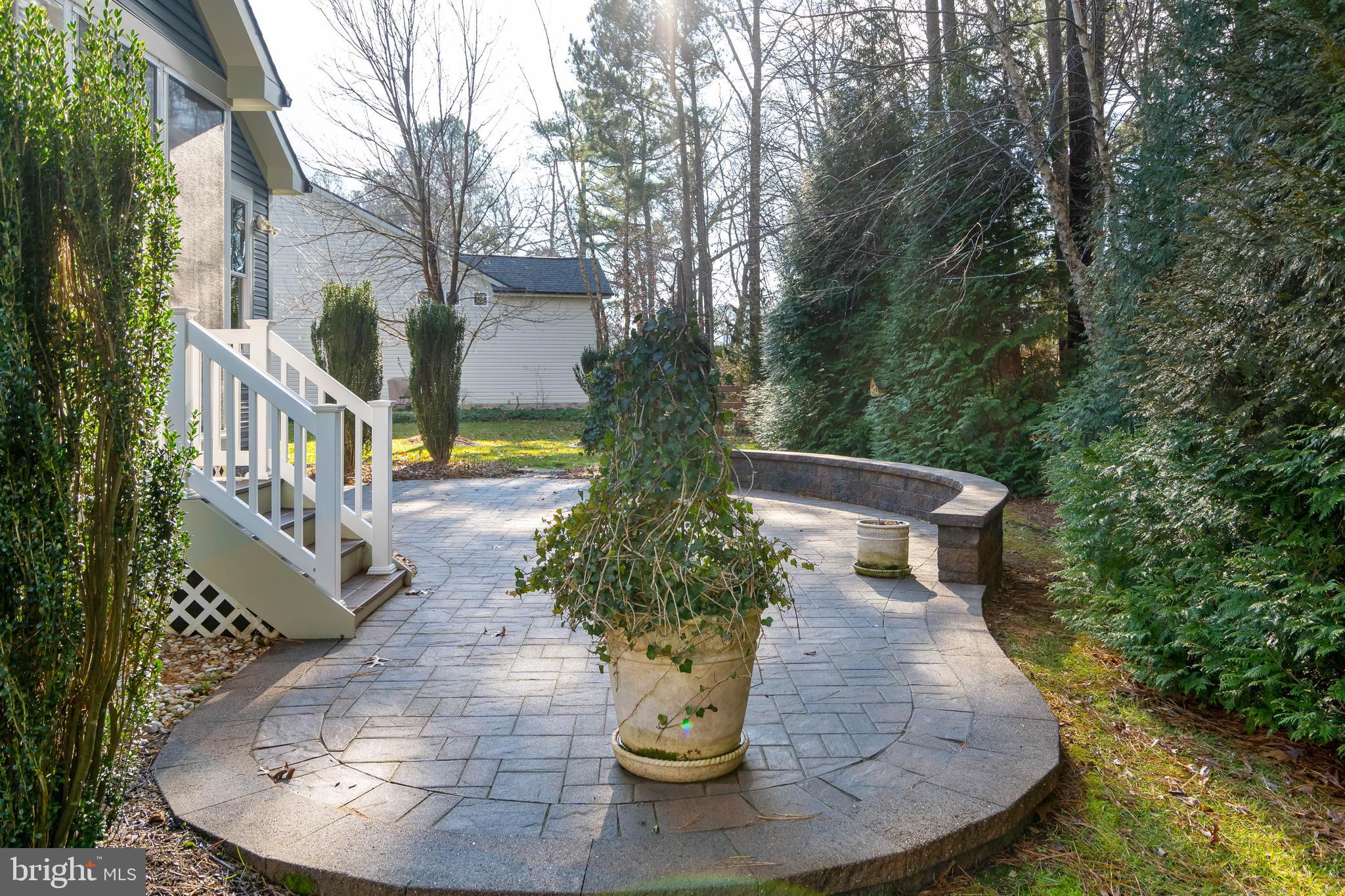 31047 Scissorbill Road Ocean View, DE 19970 - Photo 36 of 79 Beautiful Free Form Paver Patio with Sitting Wall