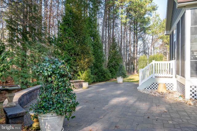 an aerial view of a house with a yard basket ball court and outdoor seating