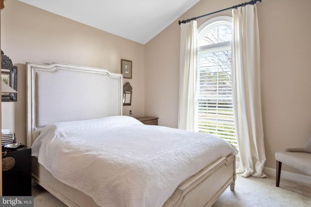 a bathroom with a granite countertop sink a mirror and a bathtub