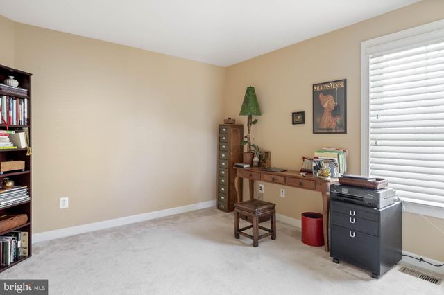 a view of an empty room with a window and fireplace