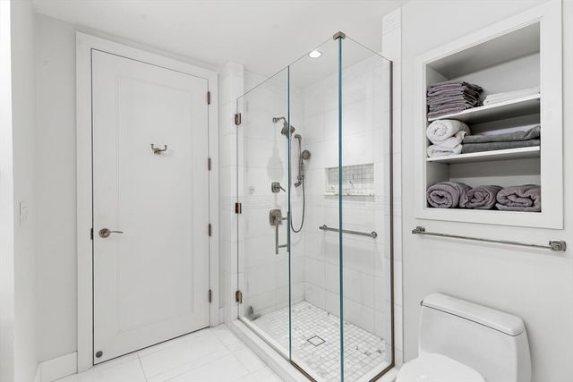 a bathroom with a shower a toilet and sink