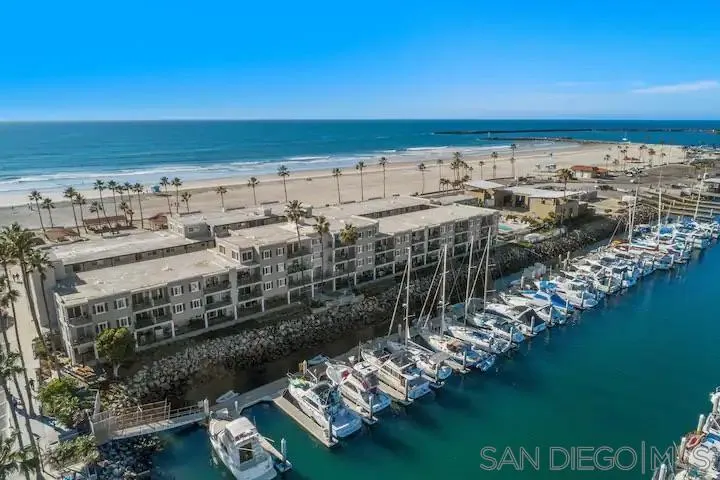 1202 North Pacific Street, Unit 106B Oceanside, CA 92054 - Photo 13 of 17 a view of ocean and building with outdoor space