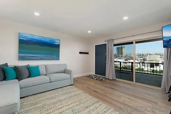1202 North Pacific Street, Unit 106B Oceanside, CA 92054 - Photo 3 of 17 a living room with furniture and a large window