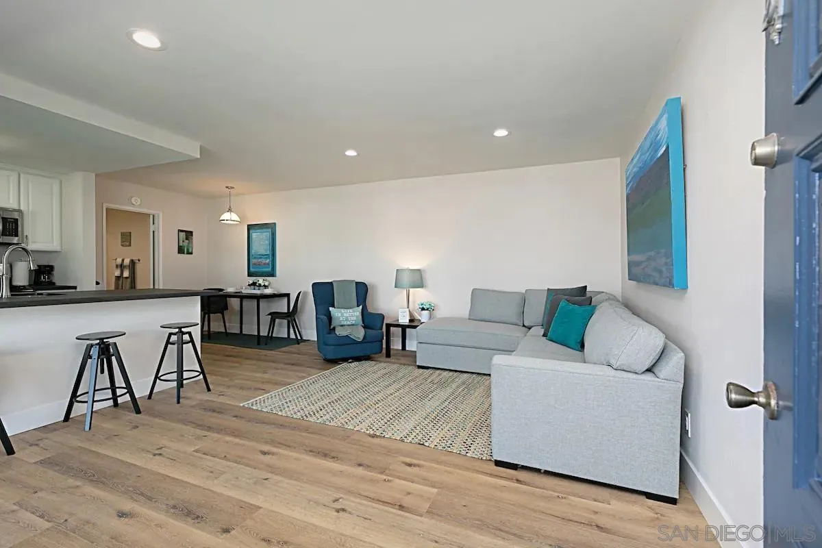 1202 North Pacific Street, Unit 106B Oceanside, CA 92054 - Photo 8 of 17 a living room with furniture and a wooden floor