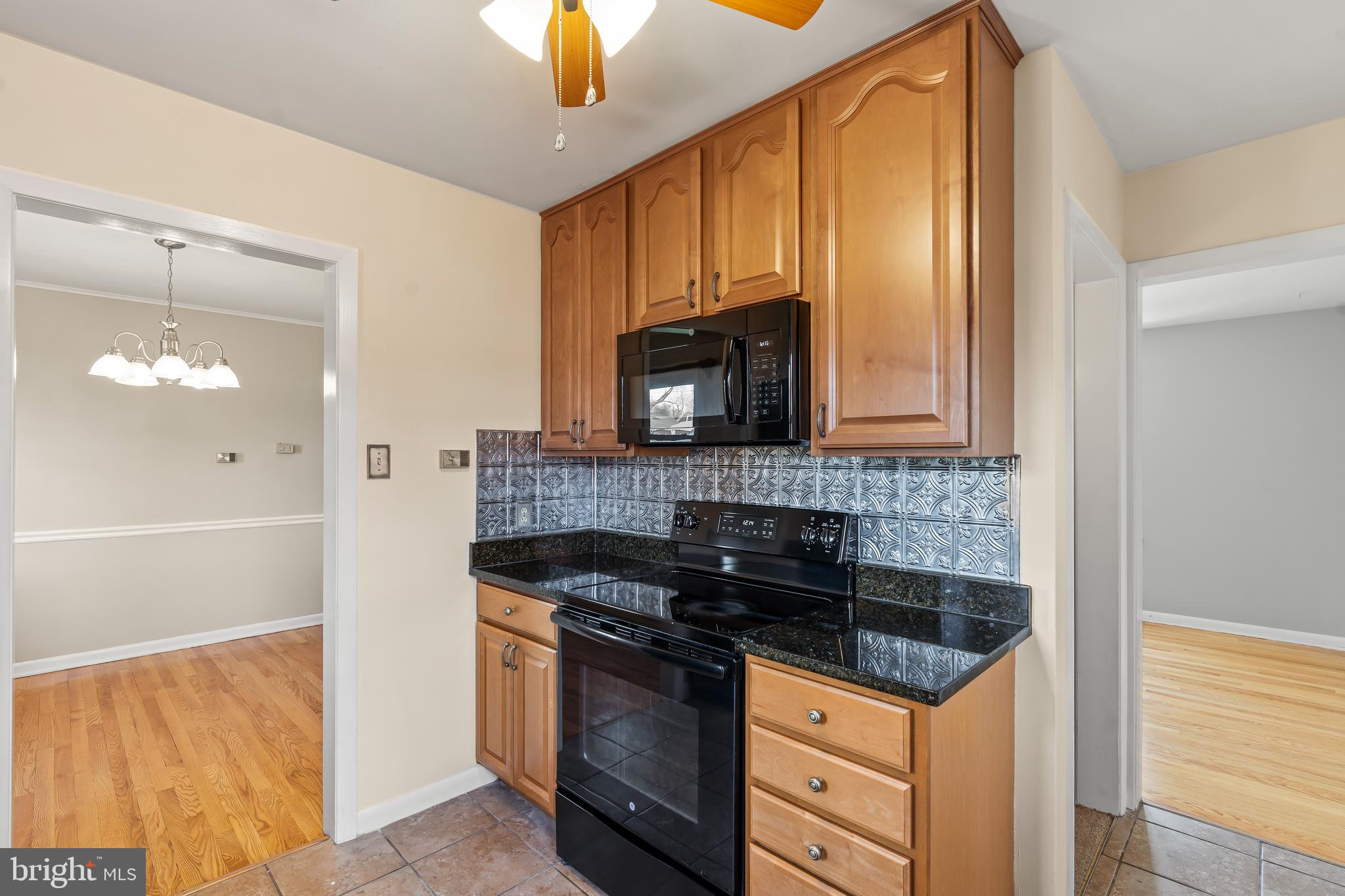 10909 Donelson Drive Williamsport, MD 21795 - Photo 11 of 37 a kitchen with stainless steel appliances granite countertop a stove and a microwave