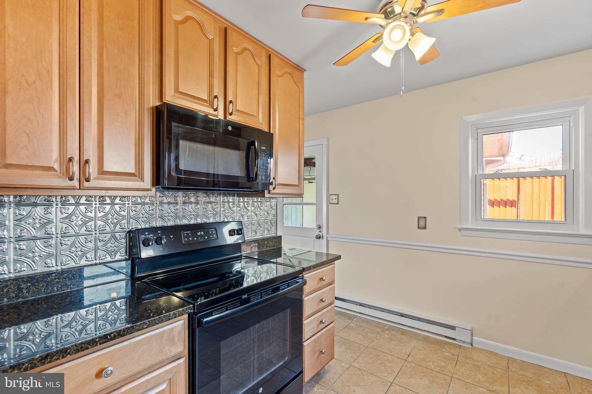 10909 Donelson Drive Williamsport, MD 21795 - Photo 13 of 37 a kitchen with stainless steel appliances granite countertop a stove a sink and a microwave