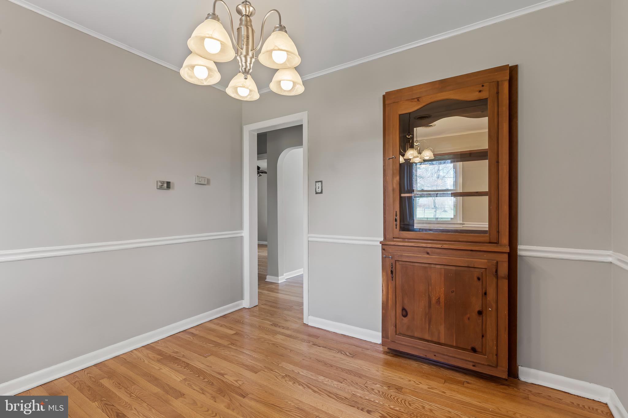 10909 Donelson Drive Williamsport, MD 21795 - Photo 15 of 37 an empty room with wooden floor cabinet and windows
