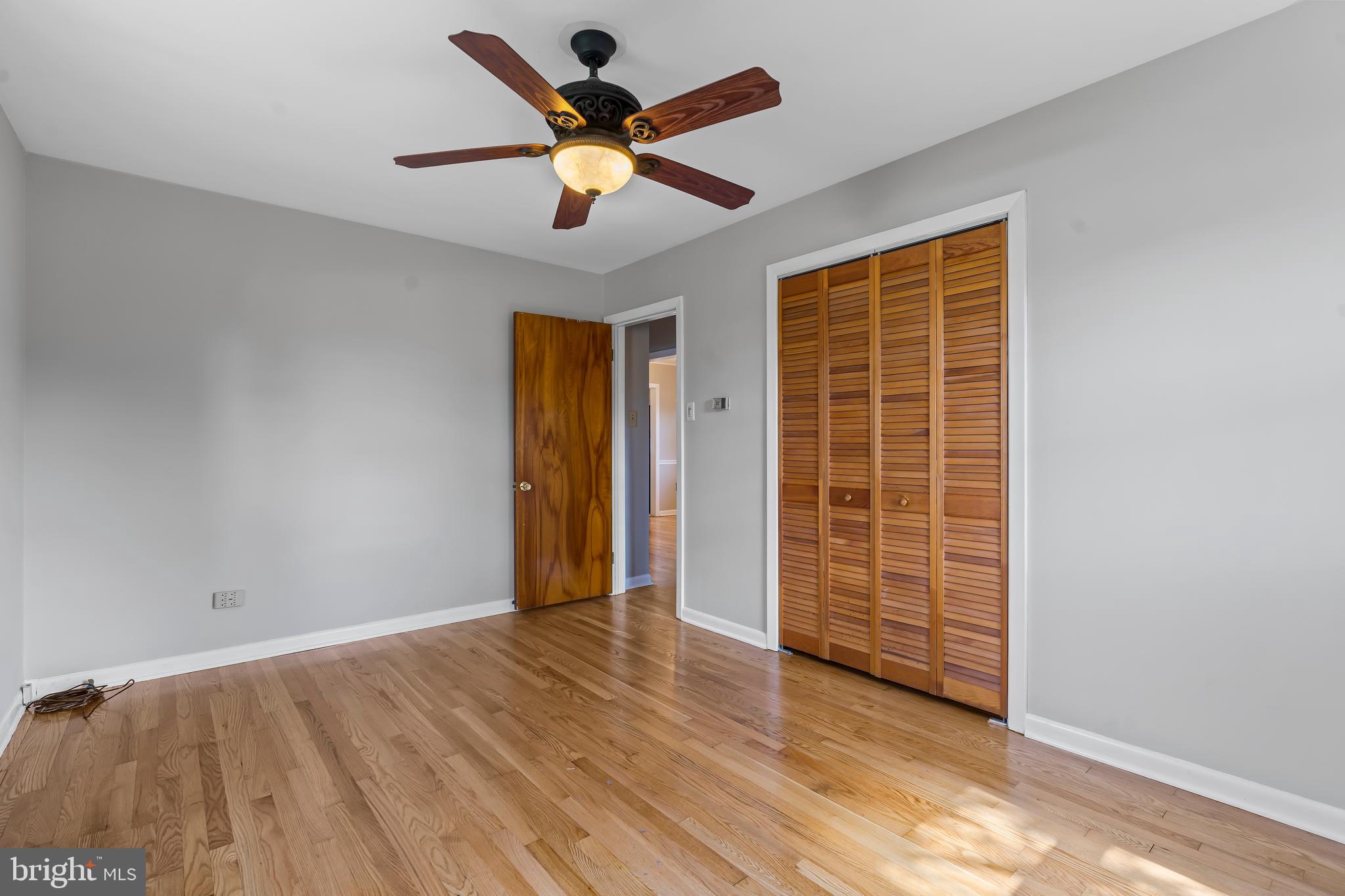 10909 Donelson Drive Williamsport, MD 21795 - Photo 16 of 37 an empty room with wooden floor and windows