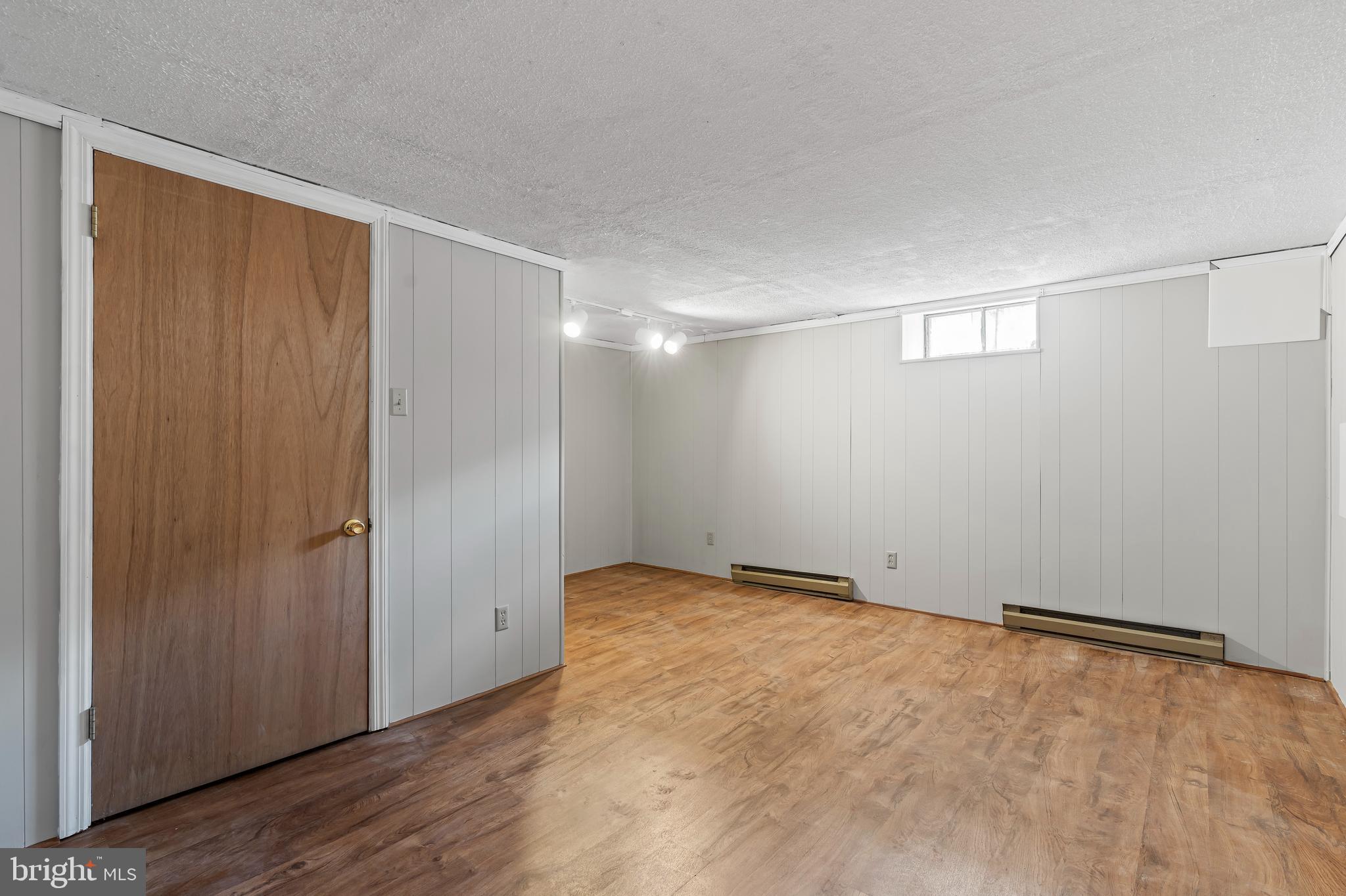 10909 Donelson Drive Williamsport, MD 21795 - Photo 24 of 37 a view of an empty room with wooden floor