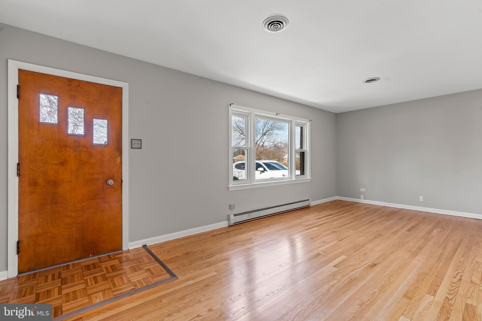10909 Donelson Drive Williamsport, MD 21795 - Photo 7 of 37 a view of an empty room with wooden floor and a window