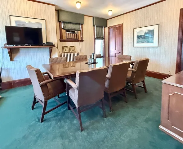 a view of a livingroom with furniture and a flat screen tv