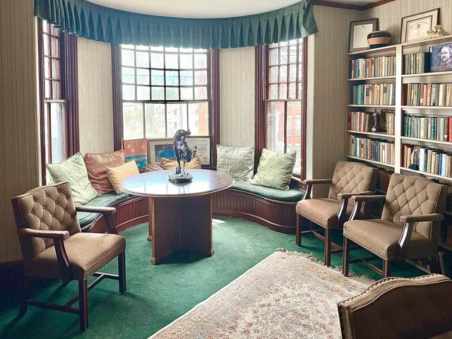 a living room with furniture and a book shelf