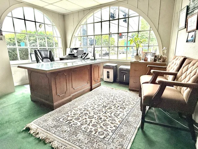 a living room with a large window and a table